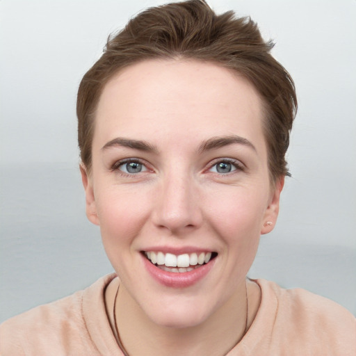 Joyful white young-adult female with short  brown hair and grey eyes