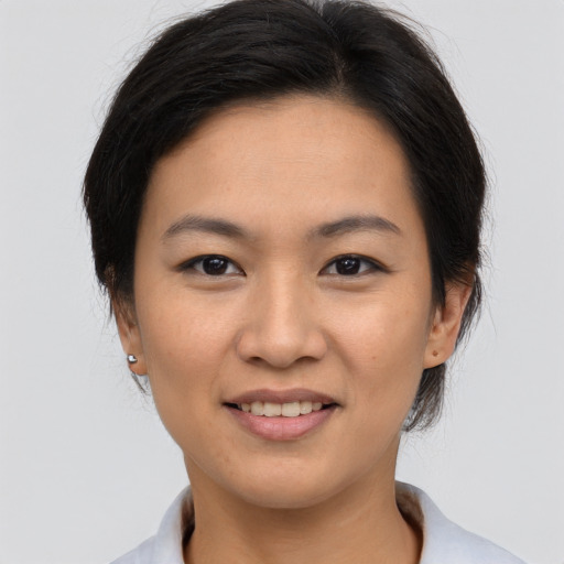 Joyful asian young-adult female with short  brown hair and brown eyes