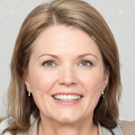 Joyful white adult female with medium  brown hair and blue eyes