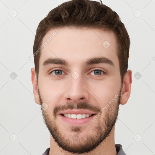 Joyful white young-adult male with short  brown hair and grey eyes