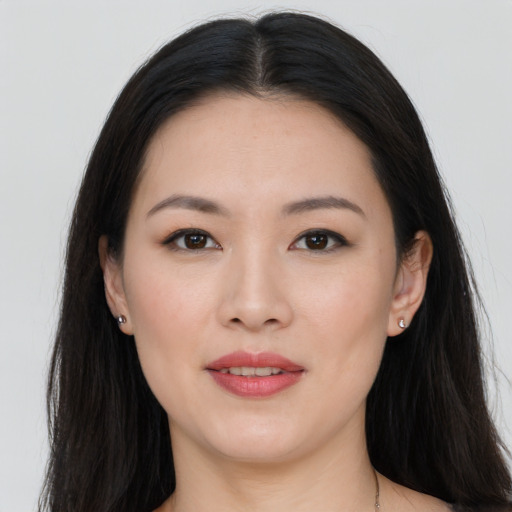 Joyful asian young-adult female with long  black hair and brown eyes