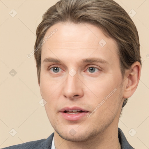 Joyful white young-adult male with short  brown hair and grey eyes