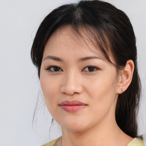Joyful asian young-adult female with medium  brown hair and brown eyes