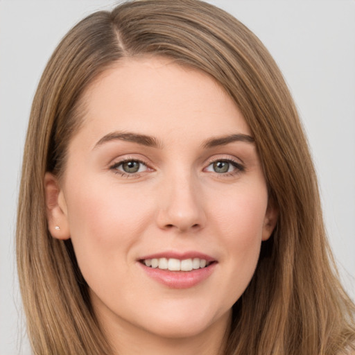 Joyful white young-adult female with long  brown hair and grey eyes