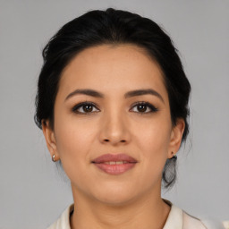 Joyful latino young-adult female with medium  brown hair and brown eyes