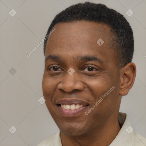 Joyful black adult male with short  brown hair and brown eyes