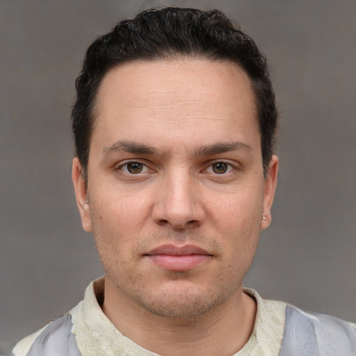 Joyful white adult male with short  brown hair and brown eyes