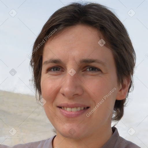 Joyful white adult female with short  brown hair and brown eyes