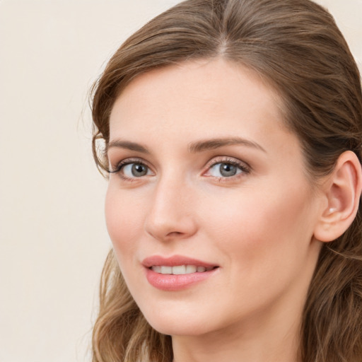 Joyful white young-adult female with long  brown hair and grey eyes