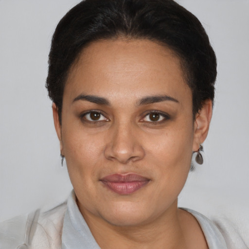 Joyful latino adult female with short  brown hair and brown eyes