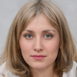 Joyful white young-adult female with medium  brown hair and blue eyes