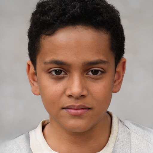Joyful latino child male with short  brown hair and brown eyes