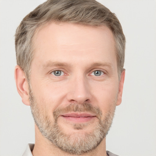 Joyful white adult male with short  brown hair and grey eyes