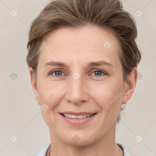 Joyful white young-adult female with short  brown hair and grey eyes