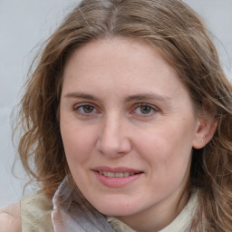 Joyful white young-adult female with medium  brown hair and blue eyes