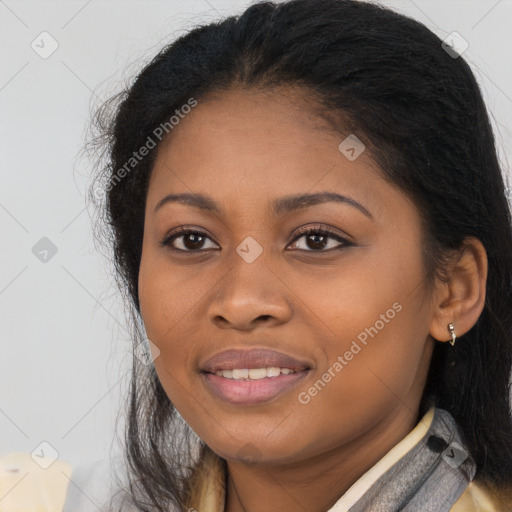 Joyful black young-adult female with long  brown hair and brown eyes