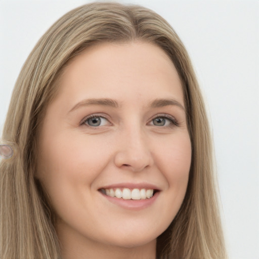 Joyful white young-adult female with long  brown hair and grey eyes