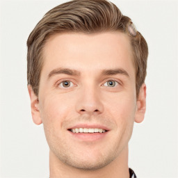 Joyful white young-adult male with short  brown hair and grey eyes
