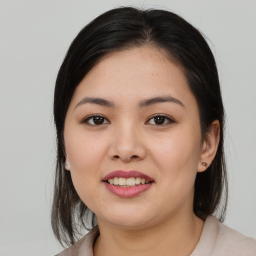 Joyful asian young-adult female with medium  brown hair and brown eyes