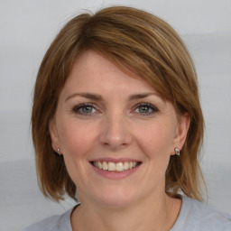 Joyful white young-adult female with medium  brown hair and blue eyes