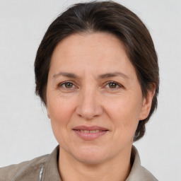 Joyful white adult female with medium  brown hair and brown eyes