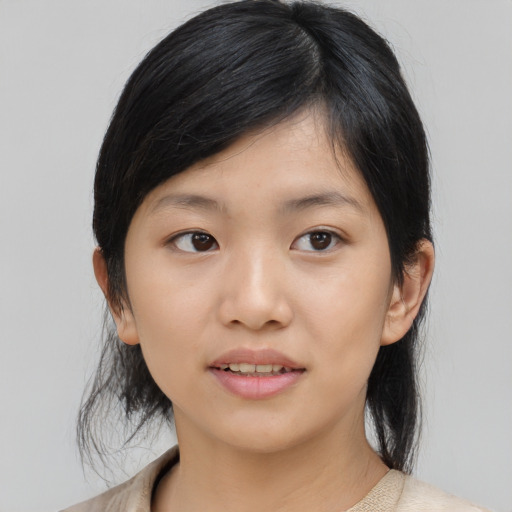 Joyful asian young-adult female with medium  black hair and brown eyes