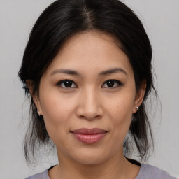 Joyful asian young-adult female with medium  brown hair and brown eyes