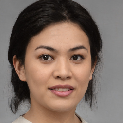 Joyful asian young-adult female with medium  black hair and brown eyes