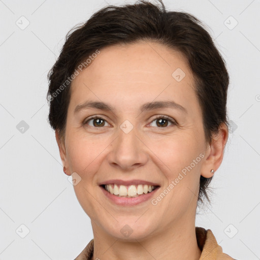 Joyful white adult female with short  brown hair and brown eyes