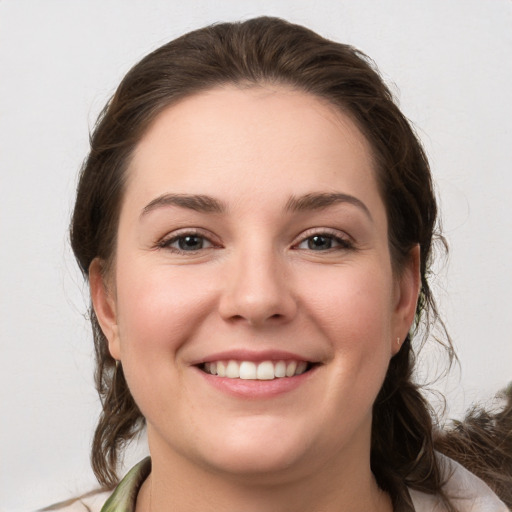 Joyful white young-adult female with medium  brown hair and grey eyes