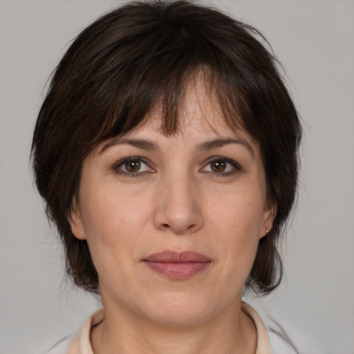 Joyful white adult female with medium  brown hair and brown eyes