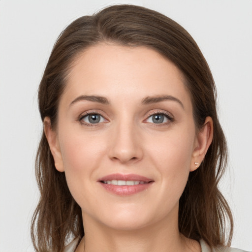 Joyful white young-adult female with long  brown hair and grey eyes