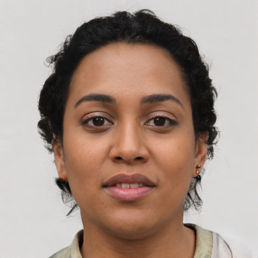 Joyful latino young-adult female with short  brown hair and brown eyes