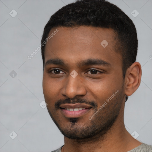 Joyful black young-adult male with short  black hair and brown eyes