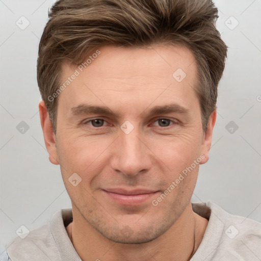 Joyful white adult male with short  brown hair and grey eyes