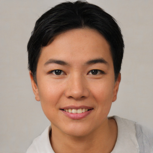 Joyful asian young-adult female with short  black hair and brown eyes
