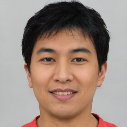 Joyful asian young-adult male with short  black hair and brown eyes