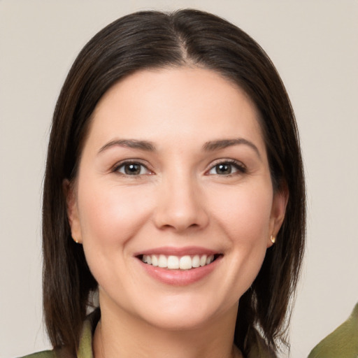 Joyful white young-adult female with medium  brown hair and brown eyes