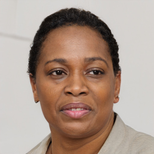Joyful black adult female with short  black hair and brown eyes