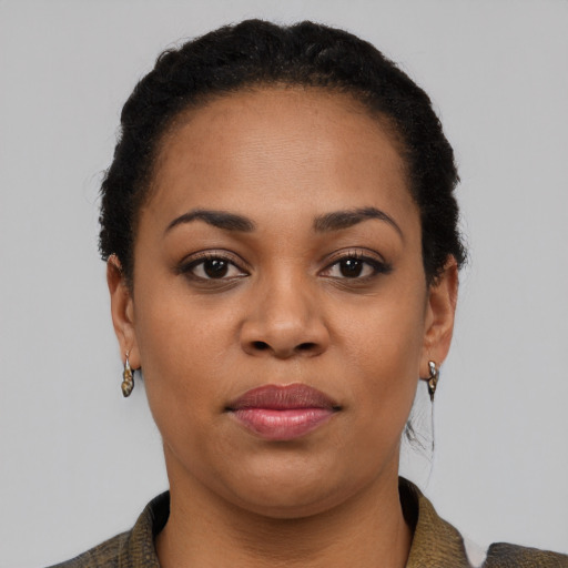 Joyful black young-adult female with short  black hair and brown eyes