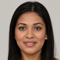 Joyful latino young-adult female with long  brown hair and brown eyes