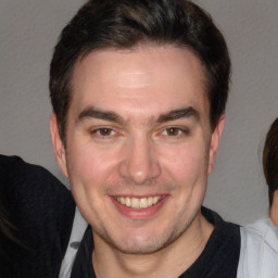 Joyful white adult male with short  brown hair and brown eyes