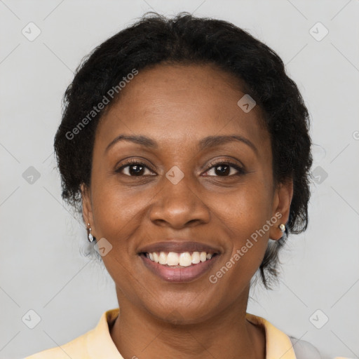 Joyful black adult female with short  brown hair and brown eyes