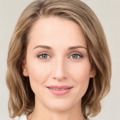 Joyful white young-adult female with medium  brown hair and green eyes