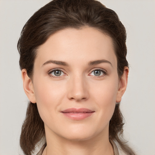 Joyful white young-adult female with medium  brown hair and grey eyes