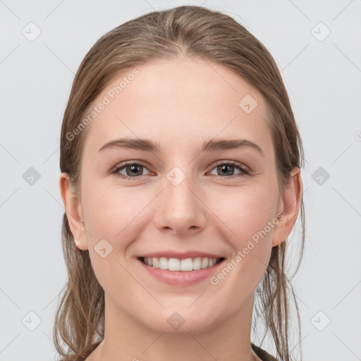 Joyful white young-adult female with long  brown hair and grey eyes