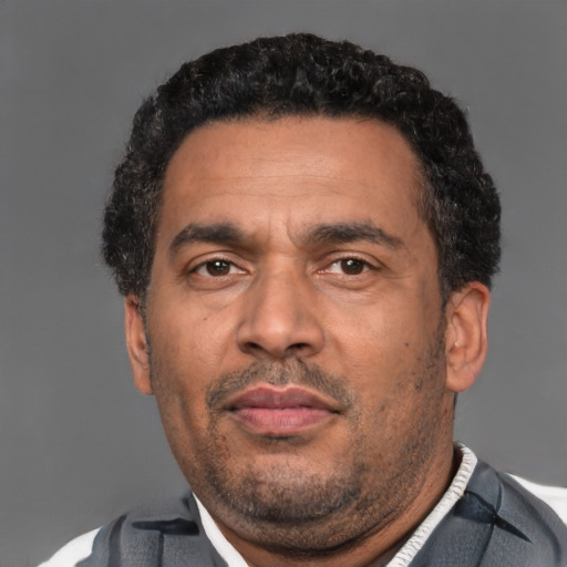 Neutral latino adult male with short  black hair and brown eyes