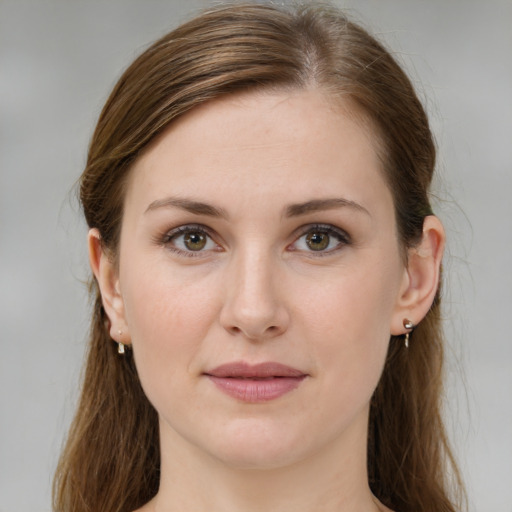 Joyful white young-adult female with long  brown hair and green eyes