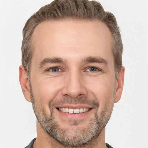 Joyful white adult male with short  brown hair and brown eyes