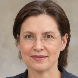 Joyful white adult female with medium  brown hair and grey eyes